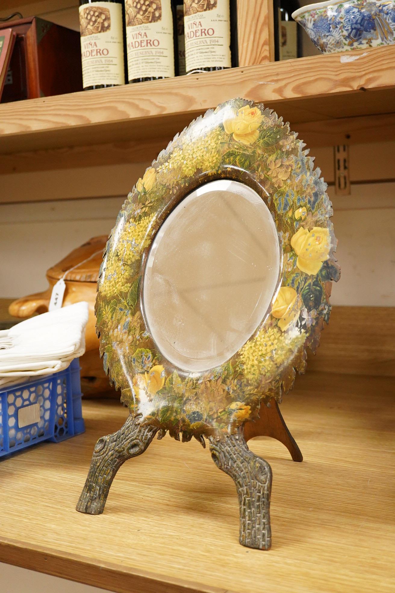 A dressing mirror, naturalistically designed with painted foliate decoration and branch effect legs, 42cm high